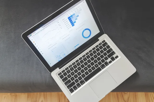 Overhead view of a laptop showing data visualizations and charts on its screen. How to assess England's marketing automation market with no official revenue figures
