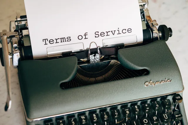 Close-up of a vintage typewriter printing 'Terms of Service' on paper, ideal for legal and business themes. Marketing automation service standards: a review framework